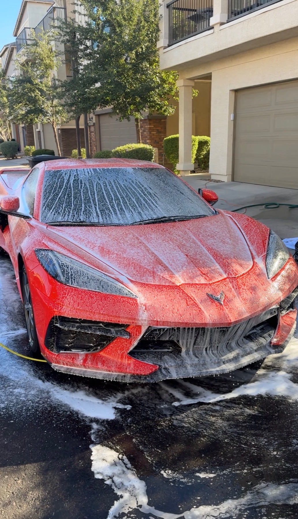 Red Corvette being washed with foam