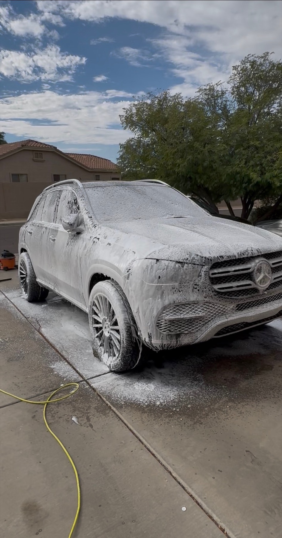 White SUV being washed with foam